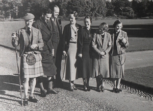 [MB2/L19/p.17 from left to right: Edward VIII; Mountbatten; Esmond Harmsworth; Mrs Rogers; Wallis Simpson; Gladys Buist; and Edwina Mountbatten, in the grounds of Balmoral]