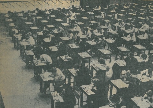 MS310/9 A816 Photo showing University students sitting final examinations in St Mary’s Drill Hall, Southampton, 3 June 1959; from the scrapbook of Isabel Syed, 1958-60. Due to the large increase in student numbers in the ‘50s there were too many finalists to seat in the University Assembly Hall; exams were sat off-campus in 1958 and 1959.